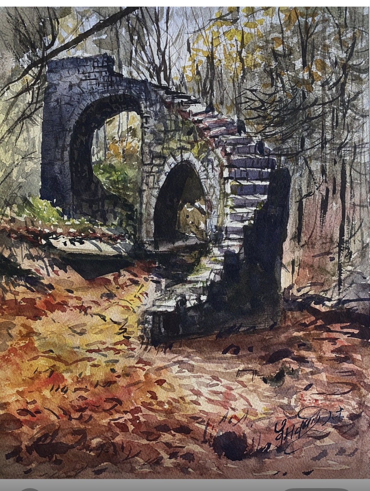 Stone bridge arches in autumn forest